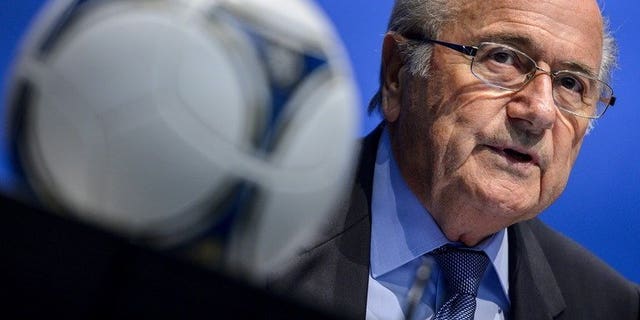 FIFA President Sepp Blatter looks on behind a football during a press conference on September 28, 2012 in Zurich. Blatter will push for the 2022 World Cup in Qatar to be moved to the winter after getting a personal taste of the Middle East's blast furnace climate.