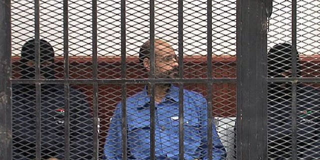 Seif al-Islam, son of Libya's late dictator Moamer Kadhafi, is pictured in the accused cell as he stands trial on May 2, 2013 in Libya's northwestern town of Zintan. The ICC on Thursday rejected Tripoli's request to suspend the handover of Seif al-Islam.
