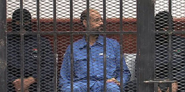 Seif al-Islam, son of Libya's late dictator Moamer Kadhafi, is pictured in the accused cell as he stands trial on May 2, 2013 in Libya's northwestern town of Zintan. The ICC on Thursday rejected Tripoli's request to suspend the handover of Seif al-Islam.