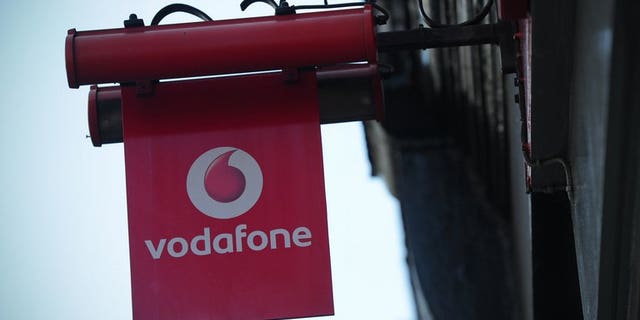 A sign outside a Vodafone shop in London. British mobile phone giant Vodafone said on Friday that sales grew in the first quarter, as strength in emerging markets countered weakness in Europe.