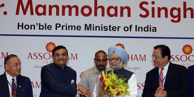 Manmohan Singh (centre right) at a meeting of industry leaders in New Delhi on Friday. India's Prime Minister urged investors to "remain optimistic", while acknowledging growth in 2013-14 is likely to fall short of the government's 6.5% target.