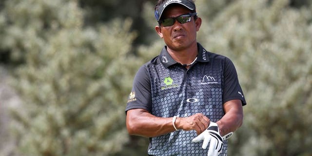Thailand's Thongchai Jaidee prepares to play the eighth tee during the first round of the 2013 British Open Golf Championship at Muirfield golf course at Gullane in Scotland on July 18, 2013. Thongchai bowed out from the British Open on Friday despite battling to a second round even-par 71.