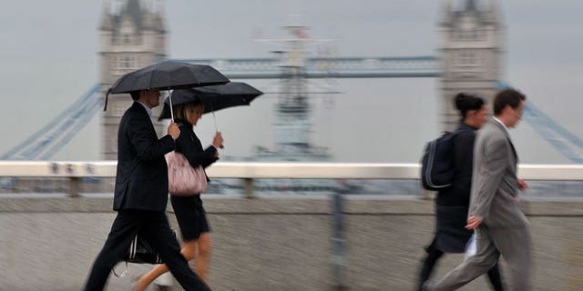 City workers walk over London Bridge. London shares closed steady on Friday, retaining the week's gains, as market heavyweight Vodafone rose after unveiling higher sales for its latest quarter.