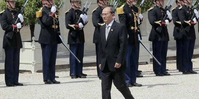 Myanmar President Thein Sein passes by the French Republican Guards at the Elysee presidential palace on July 17, 2013 in Paris. Sein denied on Friday accusations of ethnic cleansing against Rohingya Muslims, saying the claims were part of a "smear campaign" against his government.