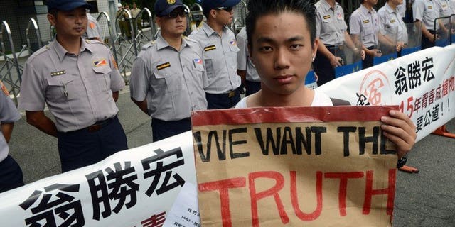 A protester during an anti-military rally outside the defence ministry in Taipei on July 20, 2013. Thousands of protesters demanded justice for a corporal who died after allegedly being abused in the military, in a case that sparked anger across Taiwan.