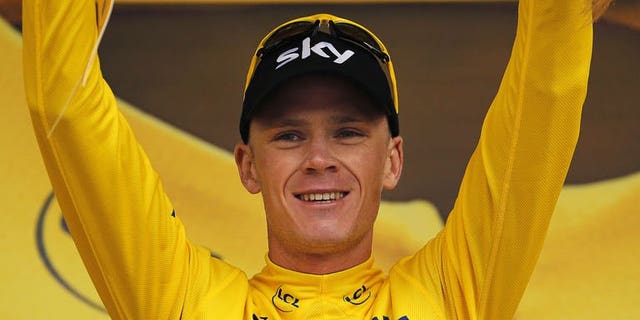 Britain's Christopher Froome celebrates his overall leader yellow jersey on the podium at the end of the 19th stage of the 100th edition of the Tour de France on July 19, 2013 between Bourg-d'Oisans and Le Grand-Bornand, French Alps.