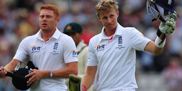 England's Joe Root (right) acknowledges the crowd as he leaves the field on the third day of the second Ashes cricket Test match against Australia Lord's in London, on July 20, 2013. Australia have been set a target of 583 to win the match as England declare their second innings on the fourth morning,