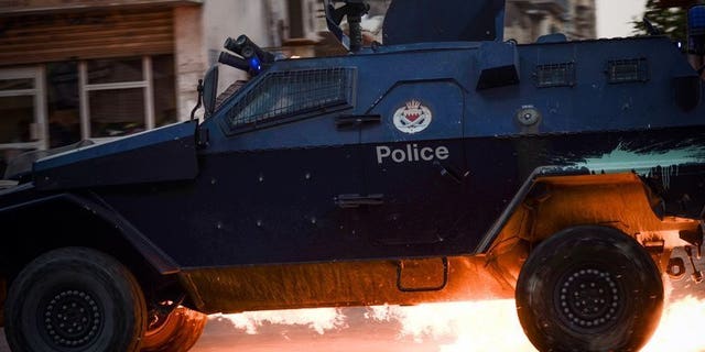 A Bahraini riot-police car is hit by a petrol bomb during clashes in the village of Saar, on June 26, 2013. The Bahraini authorities have arrested three suspects linked to a car bomb that exploded outside a Sunni mosque on the outskirts of Manama.