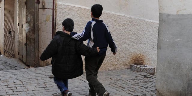 Children walk in a narrow street of the Kasbah of Algiers on March 22, 2013, in Algeria. The country's public prosecutor on Sunday demanded the death penalty for two men on trial for abducting and murdering two boys aged nine and 10, the news agency APS reported.