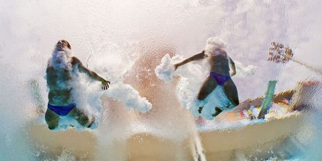In a picture taken with an underwater camera Germany's Sascha Klein and Patrick Hausding compete in the men's 10-metre synchro platform preliminary diving event in the FINA World Championships at the Piscina Municipal de Montjuic in Barcelona on July 21, 2013.