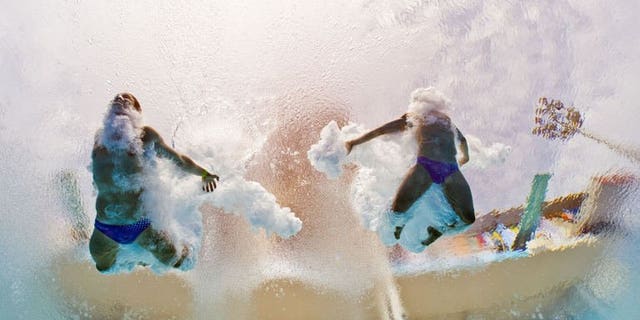 In a picture taken with an underwater camera Germany's Sascha Klein and Patrick Hausding compete in the men's 10-metre synchro platform preliminary diving event in the FINA World Championships at the Piscina Municipal de Montjuic in Barcelona on July 21, 2013.