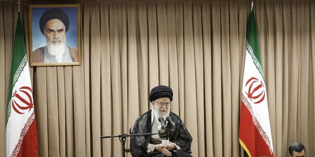 A picture released by the website of Iranian supreme leader Ayatollah Ali Khamenei (C) shows him speaking at a meeting with Iranian officials in the presence of outgoing President Mahmoud Ahmadinejad (R) in Tehran on July 21, 2013. Khamenei warned that Washington was "not trustworthy", after former US officials and lawmakers urged diplomacy with the Islamic republic's incoming president.