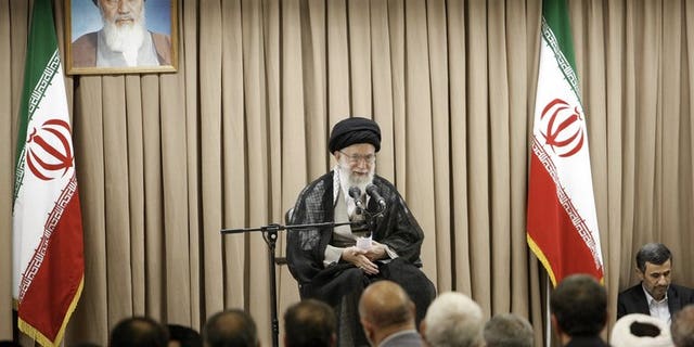 A picture released by the website of Iranian supreme leader Ayatollah Ali Khamenei (C) shows him speaking at a meeting with Iranian officials in the presence of outgoing President Mahmoud Ahmadinejad (R) in Tehran on July 21, 2013. Khamenei warned that Washington was "not trustworthy", after former US officials and lawmakers urged diplomacy with the Islamic republic's incoming president.