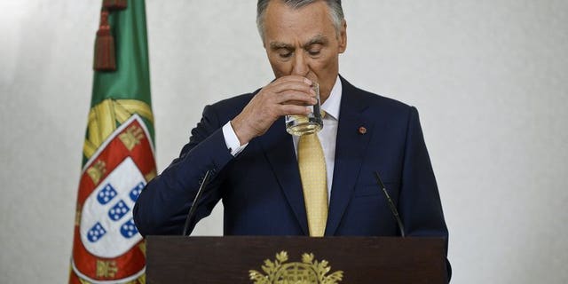 Portuguese President Anibal Cavaco Silva takes a drink as he addresses the nation from Belem Presidential palace in Lisbon on July 21, 2013. Cavaco Silva voiced support for the country's centre-right coalition government and rejected calls for snap elections to resolve a political crisis shaking the bailed-out nation.