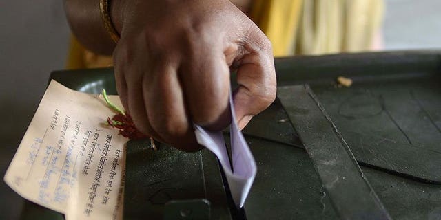 An Indian voter casts her ballot at a polling station in the village Meera Kot, on the outskirts of Amritsar, on May 19, 2013. India's top law officer has called for a ban on opinion polls during campaigning in next year's general election in the world's largest democracy, according to a report in the Hindustan Times.