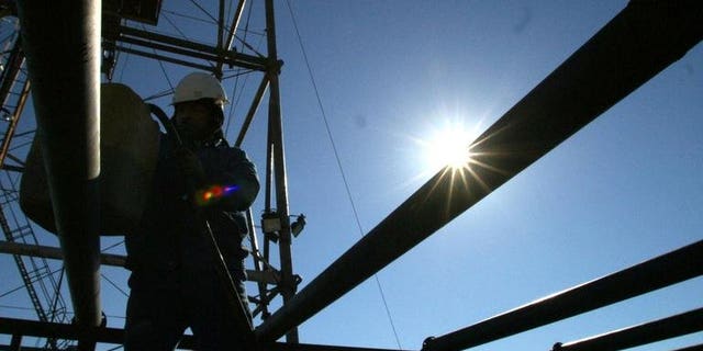 Oil experts work at the Khabbaz productive site, 320 north of Baghdad, on January 5, 2003. Iraqi oil exports fell in June for the second month in a row as poor weather hit southern ports and saboteurs damaged a key pipeline, the oil ministry said Monday.