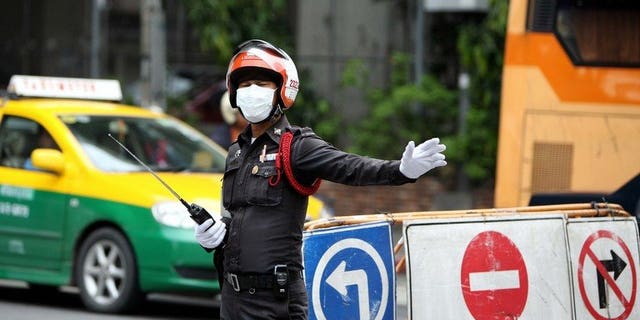 Illustration of a Thai traffic police officer. Nineteen people were killed and 20 hurt Tuesday when a double decker coach collided with a truck in central Thailand and burst into flames, authorities said.