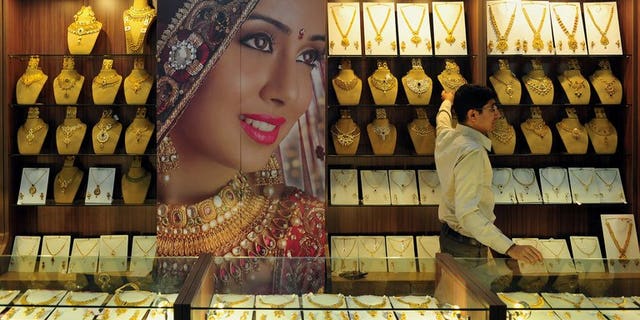 An Indian jewellery store worker pictured in Bangalore on October 14, 2011. India, the world's biggest gold-buying nation, has slapped fresh curbs on imports of the precious metal in a bid to curb a record current account deficit.