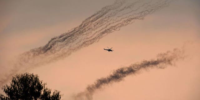 A Congolese army helicopter flies amidst smoke from rockets fired at M23 positions north of Goma in the east of the Democratic Republic of the Congo on July 17, 2013. Three Congolese army helicopters on Tuesday blasted positions of the rebel M23 movement near the eastern Democratic Republic of Gongo (DRC) provincial capital of Goma.