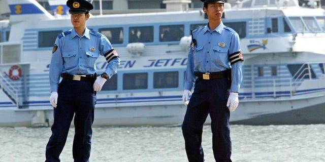 Japanese policemen patrol the Niigata Port, on June 8, 2003. Police on Friday arrested a man who left a "haiku" poem when he disappeared after five people were murdered in a tiny mountain village.
