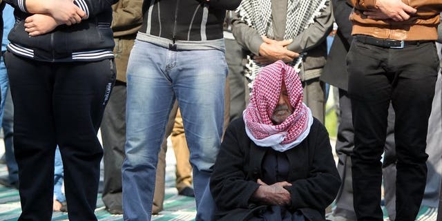Iraqi Sunni Muslim men attend Friday prayers at the Abu Hanifa mosque in Baghdad's Adhamiya district on February 8, 2013. Bombs targeting worshippers gathered for evening prayers at three Sunni mosques in Iraq killed nine people on Tuesday, officials say.