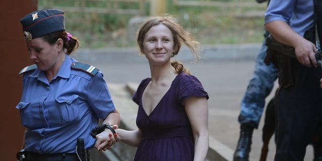 File picture shows Maria Alyokhina, a member of punk band "Pussy Riot," being escorted into court in Moscow on August 8, 2012. Alyokhina on Wednesday asked again to be released on parole after serving almost a year in prison for a protest againt President Vladimir Putin in a Moscow church.