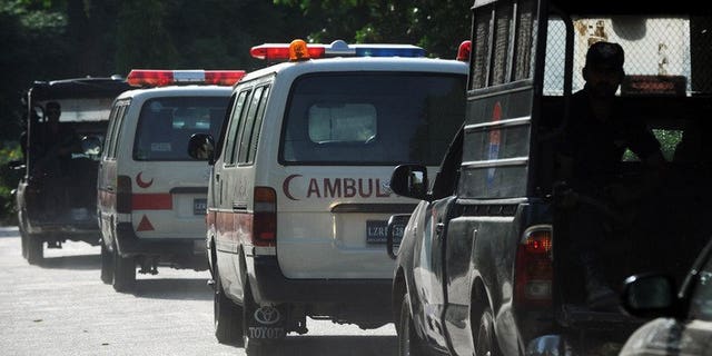 Pakistani police and ambulances are seen in Lahore on May 2, 2013. Gunmen attacked a complex housing Pakistani government security agencies in the southern town of Sukkur late Wednesday, killing five people and wounding more than 30 others, state TV said.