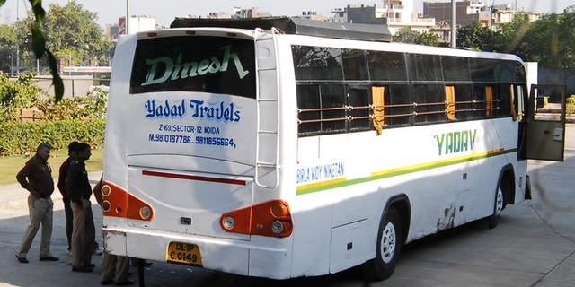 In this photograph taken on December 18, 2012, Indian policemen inspect an impounded bus, suspected to be the vehicle where five men and a youth gang-raped a student while driving around the city, at the Thyagaraj Stadium in New Delhi. An Indian court is expected to deliver the first verdict this week on one of five suspects tried over the fatal gang-rape.