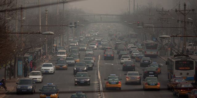 Traffic makes its way through Beijing on January 12, 2013. A Chinese man threw a two-year-old girl to the ground, killing her, after her mother apparently refused to make way for him to park his car, state media reported Thursday.