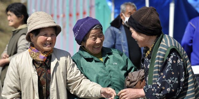 Elderly women are seen chatting in the town of Minamisanriku in Miyagi prefecture on April 5, 2011. Japan's women retook their place as the world's longest-lived last year, edging out Hong Kongers as their life expectancy bounced back from the dip caused by the 2011 tsunami, officials said.
