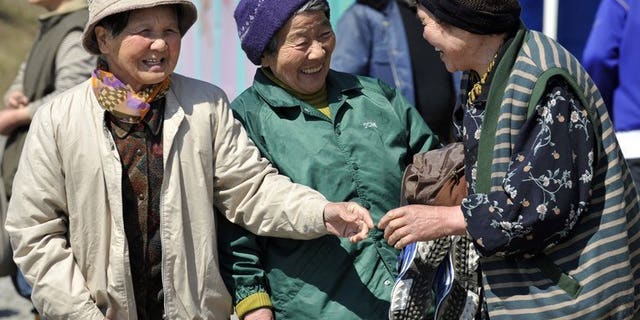 Elderly women are seen chatting in the town of Minamisanriku in Miyagi prefecture on April 5, 2011. Japan's women retook their place as the world's longest-lived last year, edging out Hong Kongers as their life expectancy bounced back from the dip caused by the 2011 tsunami, officials said.