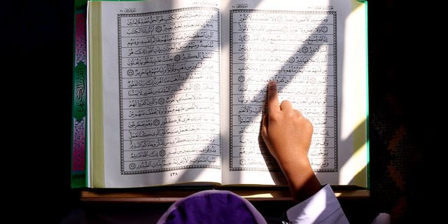 A Malaysian Muslim boy reads from the Koran inside a mosque in Kuala Lumpur on July 31, 2011. A Malaysian court on Thursday ruled against the 2009 conversion of three Hindu children to Islam without their mother's knowledge, a verdict welcomed by non-Muslim groups.