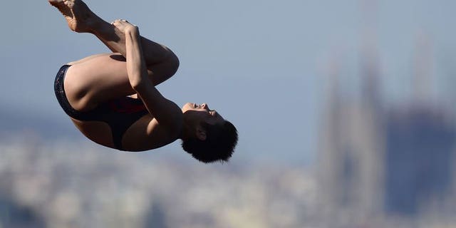 China's Si Yajie competes in the women's 10-metre platform final diving event in the FINA World Championships at the Piscina Municipal de Montjuic in Barcelona on July 25, 2013. Fourteen-year-old Si won the women's world 10m platform gold on Thursday with compatriot Chen Ruolin, the previous world and Olympic champion, in silver and Ukraine's Iulia Prokopchuk third.