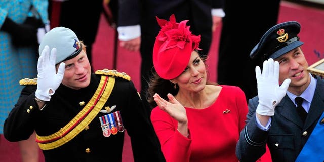 Britain's Catherine, Duchess of Cambridge, (C) Prince William (R) and Prince Harry (L) wave as they pass the Houses of Parliament in central London, on June 3, 2012. Prince Harry on Thursday promised to use his expertise to make sure his new nephew George "has fun".