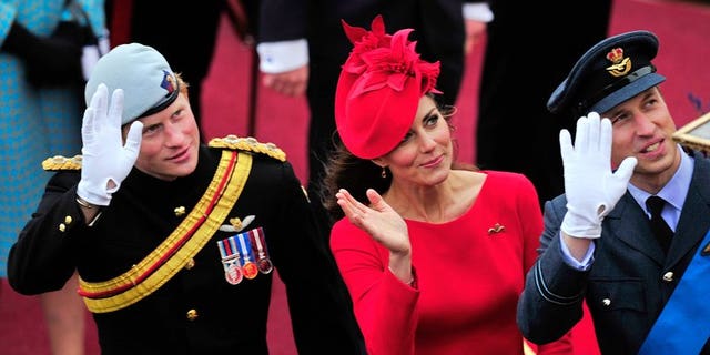 Britain's Catherine, Duchess of Cambridge, (C) Prince William (R) and Prince Harry (L) wave as they pass the Houses of Parliament in central London, on June 3, 2012. Prince Harry on Thursday promised to use his expertise to make sure his new nephew George "has fun".