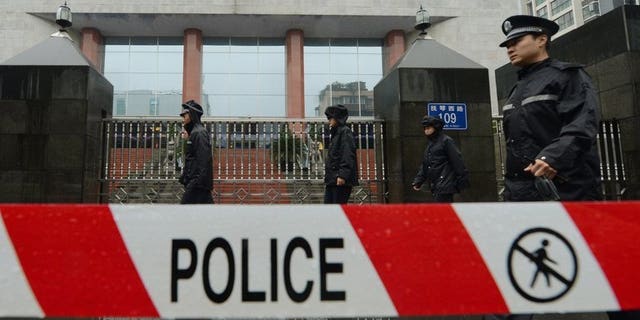 File image shows a policemen on guard outside the Chengdu People's Intermediate court in Chengdu, southwest China's Sichuan province, on September 24, 2012. A knife-wielding Chinese man has stabbed five people to death and wounded another three in the central Henan province, state media reported Friday.