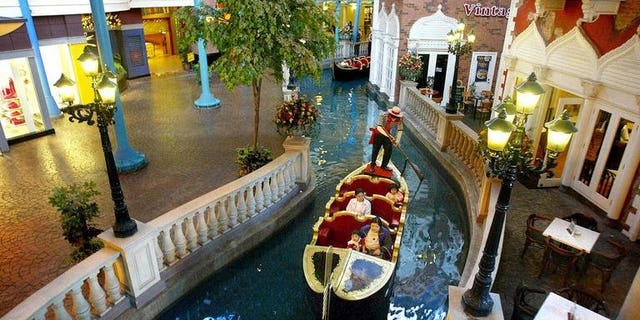 A Venician gondola carries visitors in a mini river at the new First World Plaza in Genting Highlands, north of Kuala Lumpur, on July 27, 2002. Malaysian casino operator Genting's resort unit will build a 400 million ringgit ($125 million) Twentieth Century Fox Theme Park near the capital Kuala Lumpur.