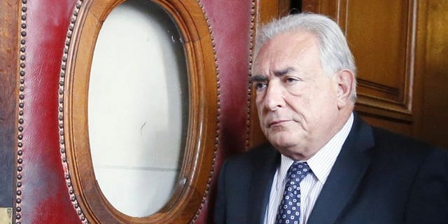 A picture taken on February 26, 2013 in Paris shows French former IMF chief Dominique Strauss-Kahn leaving a courthouse. Strauss-Kahn will face trial on pimping charges along with 12 others in connection with an alleged prostitution ring at a Lille hotel, the local prosecutors' office said.