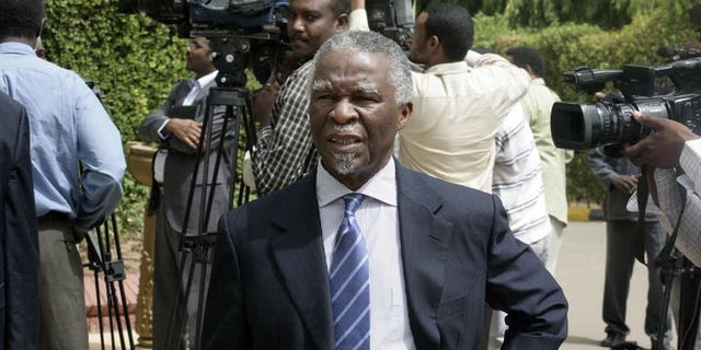South Africa's former president Thabo Mbeki walks past journalists as he leaves after a meeting with Sudanese president on July 25, 2013 in the Sudanese capital, Khartoum. He was part of securing a deal for Sudan to delay closing an economically vital pipeline carrying South Sudanese oil.