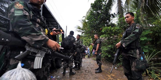 This file photo shows members of a police special action force manning a checkpoint on the southern Philippine island of Mindanao, on December 12, 2009. Six people were killed and more than two dozen wounded when a bomb exploded at a restaurant in a town on Mindanao late on Friday, July 26, 2013.
