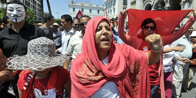 Tunisian protesters stage an anti-government demonstration on the Habib Bourguiba Avenue on July 26, 2013 in Tunis after the killing of the opposition politician Mohamed Brahmi. A bomb wounded a policeman in a car park outside a police post in the port on Saturday, a witness and two radio stations said.