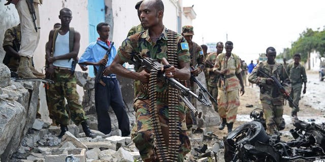 Somali National Government (SNG) soldiers are pictured after Al-Qaeda linked Shebab insurgents shot and blasted their way into the United Nations (UN) compound in Mogadishu on June 19, 2013. At least one person was killed Saturday when a car bomb exploded in Somalia's capital, the latest in a string of attacks, a local official said.