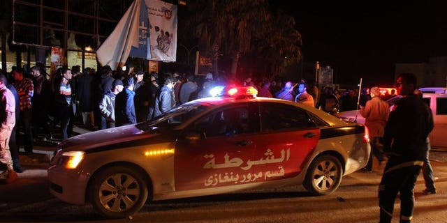 Libyans and police gather on January 14, 2013 in a central neighbourhood of Benghazi. More than 1,000 inmates escaped during a prison riot and attack on Saturday in the unruly Libyan city of Benghazi, a security official told AFP.