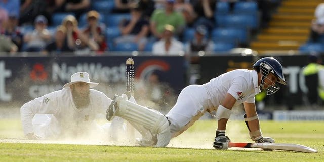 England's James Taylor (R) dives to avoid a run on August 4, 2012. He advanced his case for an England recall by making an unbeaten 64 for Sussex against Australia on the second day of three at Hove.