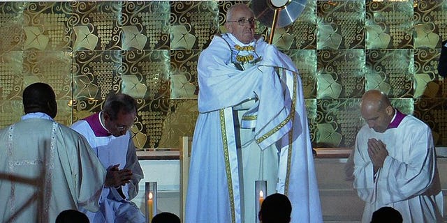 Pope Francis leads a prayer vigil with Catholic pilgrims at Copacabana beach in Rio de Janeiro on July 27, 2013. He voiced support for young protestors who have taken to the streets of Brazil in recent weeks.