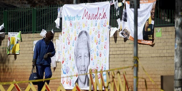 A banner with well-wishing messages left for former South African president Nelson Mandela, on July 19, 2013, outside the Pretoria hospital where he is in a critical condition. South Africa's presidency declined to comment on a report the anti-apartheid hero had undergone an operation.