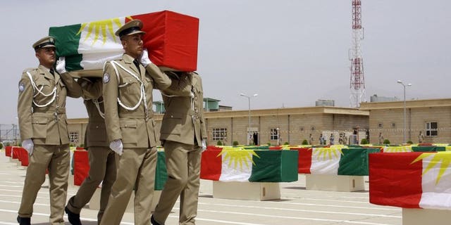 File picture shows Iraqi Kurdish police officers carrying a coffin draped with the Kurdish flag, on May 28, 2012. A suicide bomber killed eight Kurdish police in northern Iraq on Sunday, a district official and a doctor said.