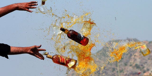 This file photo shows Pakistani officials destroying contraband alcohol, in the Shahkas area of the Jamrud Khyber Agency, on June 26, 2013. At least 18 people died and around two dozen others suffered serious health issues after partygoers at two separate events consumed toxic drinks in central Pakistan, officials said on Sunday.
