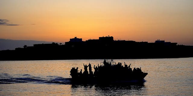 A boat carring Tunisian migrants enters the port of Lampedusa on April 12, 2011. Italian Interior Minister Angelo Alfano called for human traffickers who shuttle migrants across the sea to Italy to be stopped on Sunday, after 31 boat people drowned during an attempted crossing.