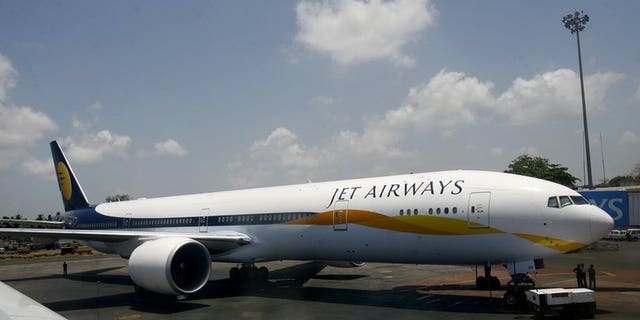 A Jet Airways Boeing 777-300ER stands on the tarmac at Chatrapati Shivaji International Airport in Mumbai on May 13, 2007. India's foreign investment panel approved a plan for Abu Dhabi-based Etihad to buy a stake in Indian airline Jet, but the pact still faces other hurdles.